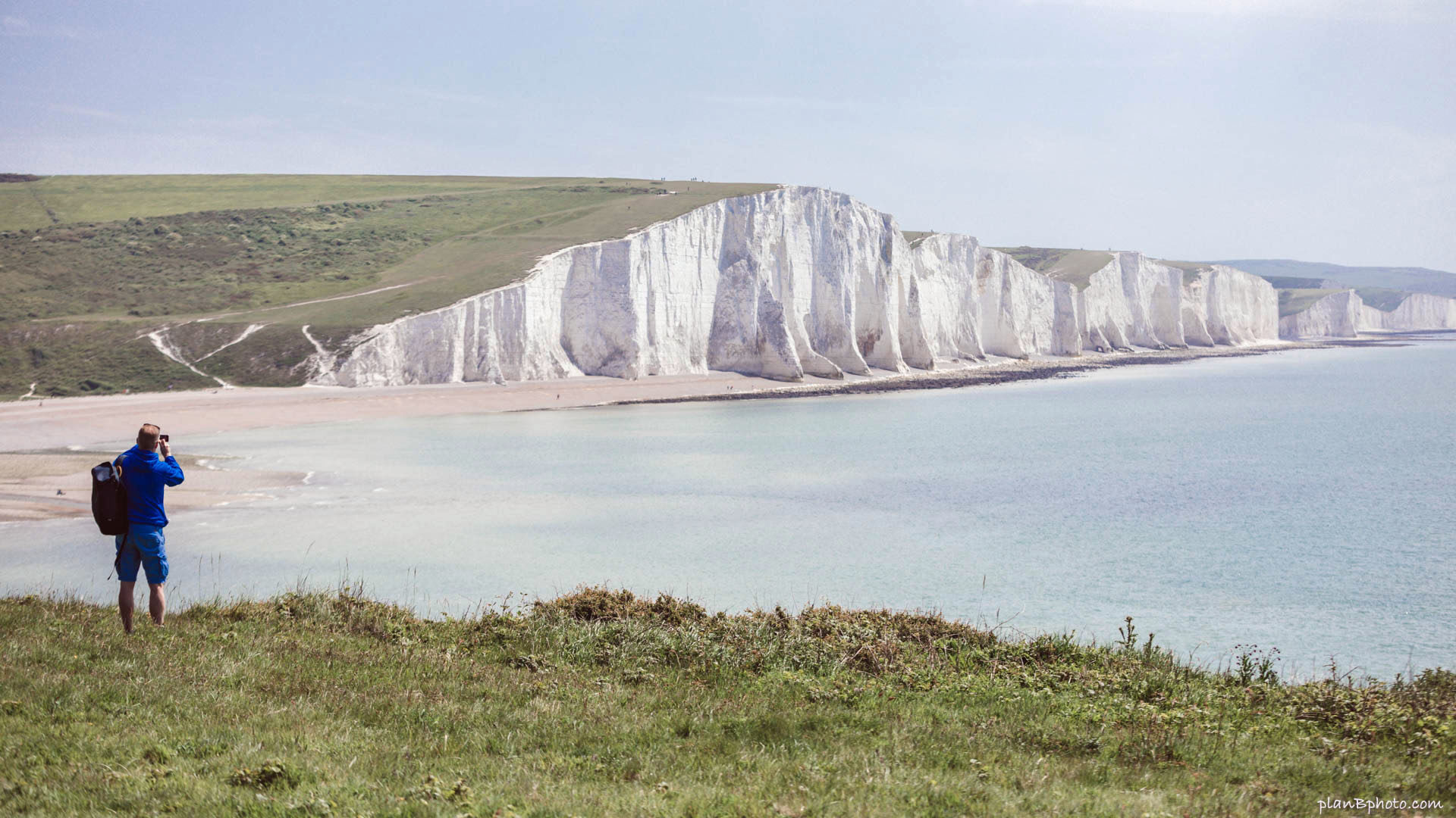 A man taking picture of Seven sisters cliffs
