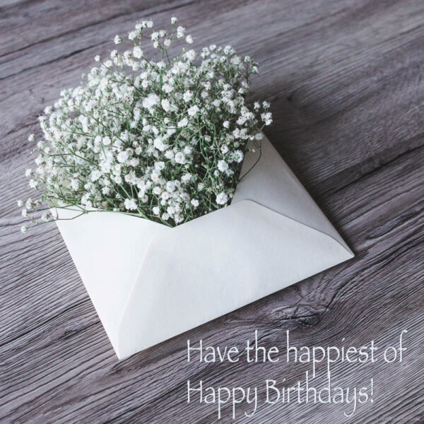 White flowers in an envelope. Birthday message
