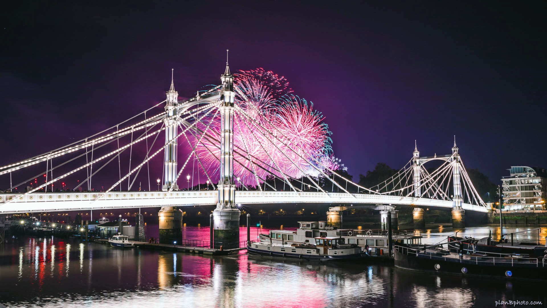 Pink fireworks behind the bridge in London