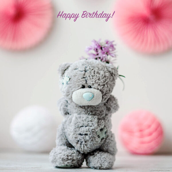 Happy Birthday image with bear hiding flowers behind his back