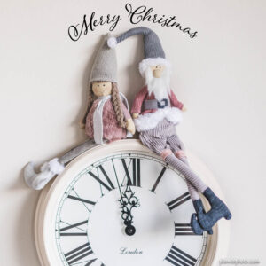 Merry Christmas wish with Santa Claus on a white clock at midnight